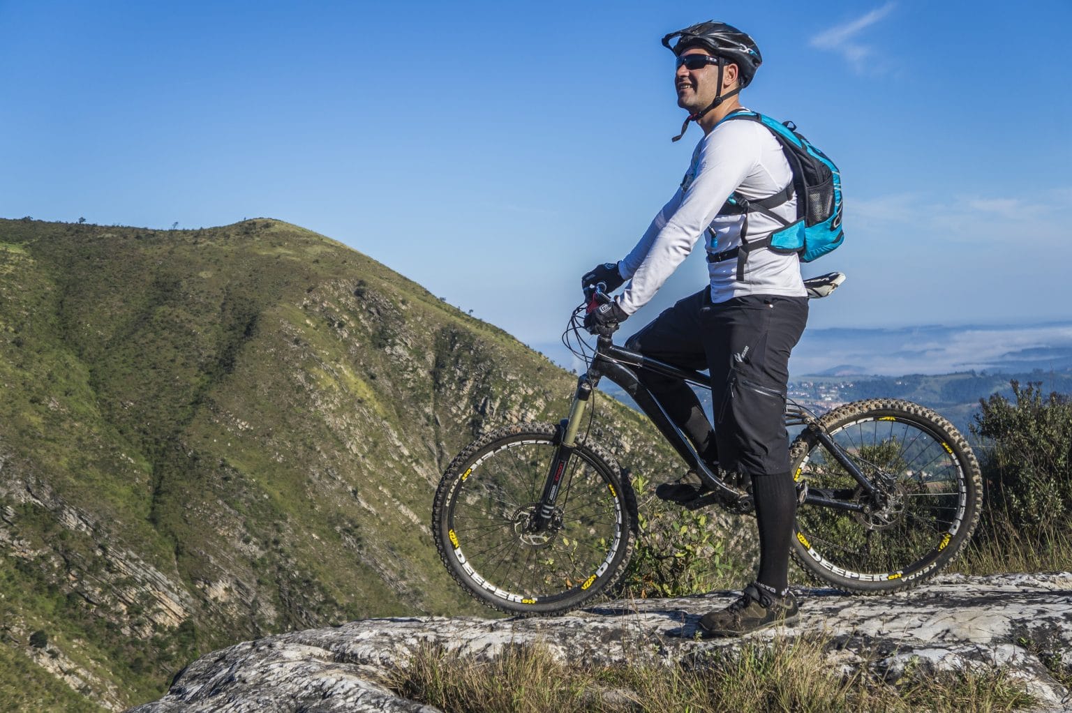 Man riding a bike through the mountains.