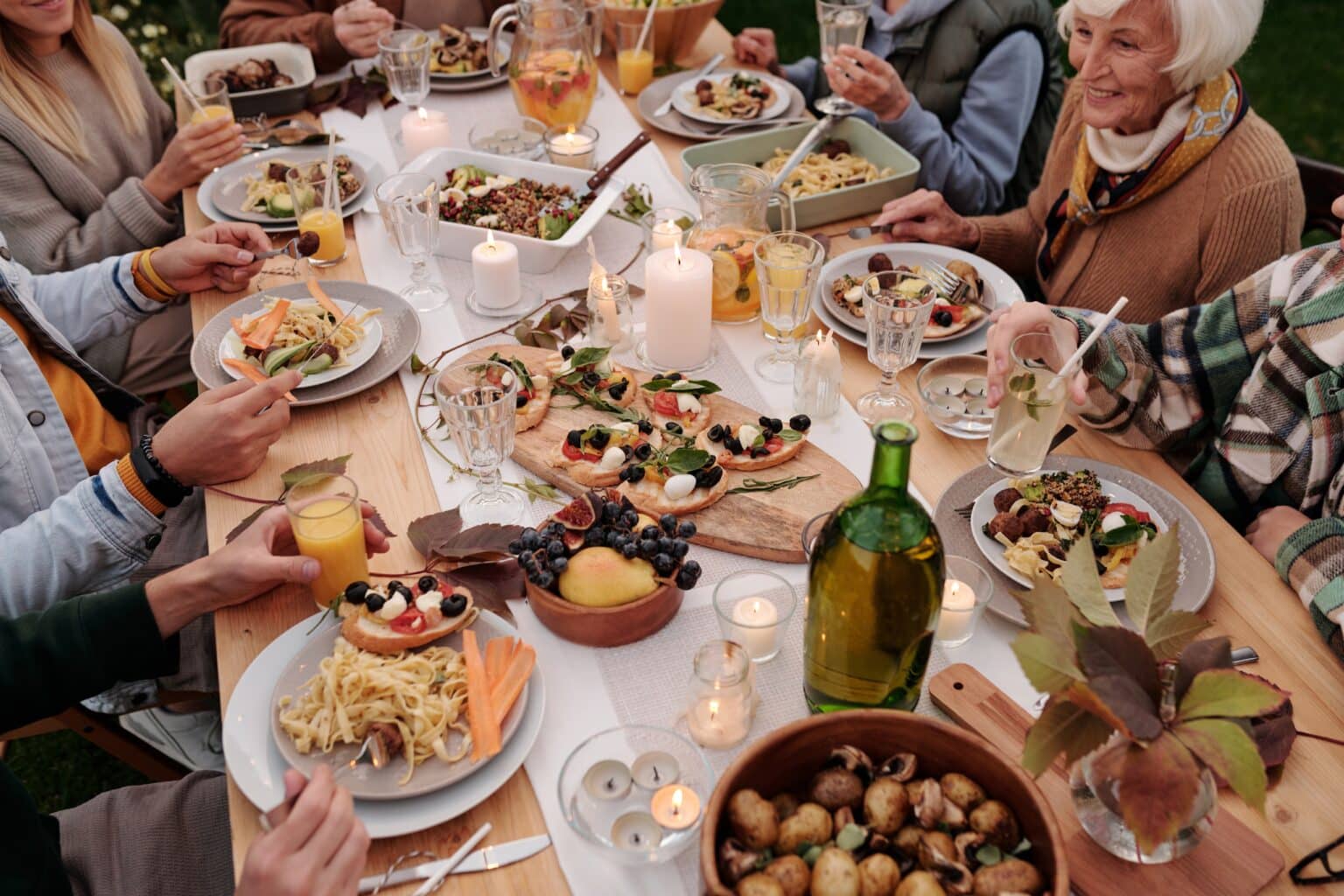 Large group of friends and family enjoying a dinner party.