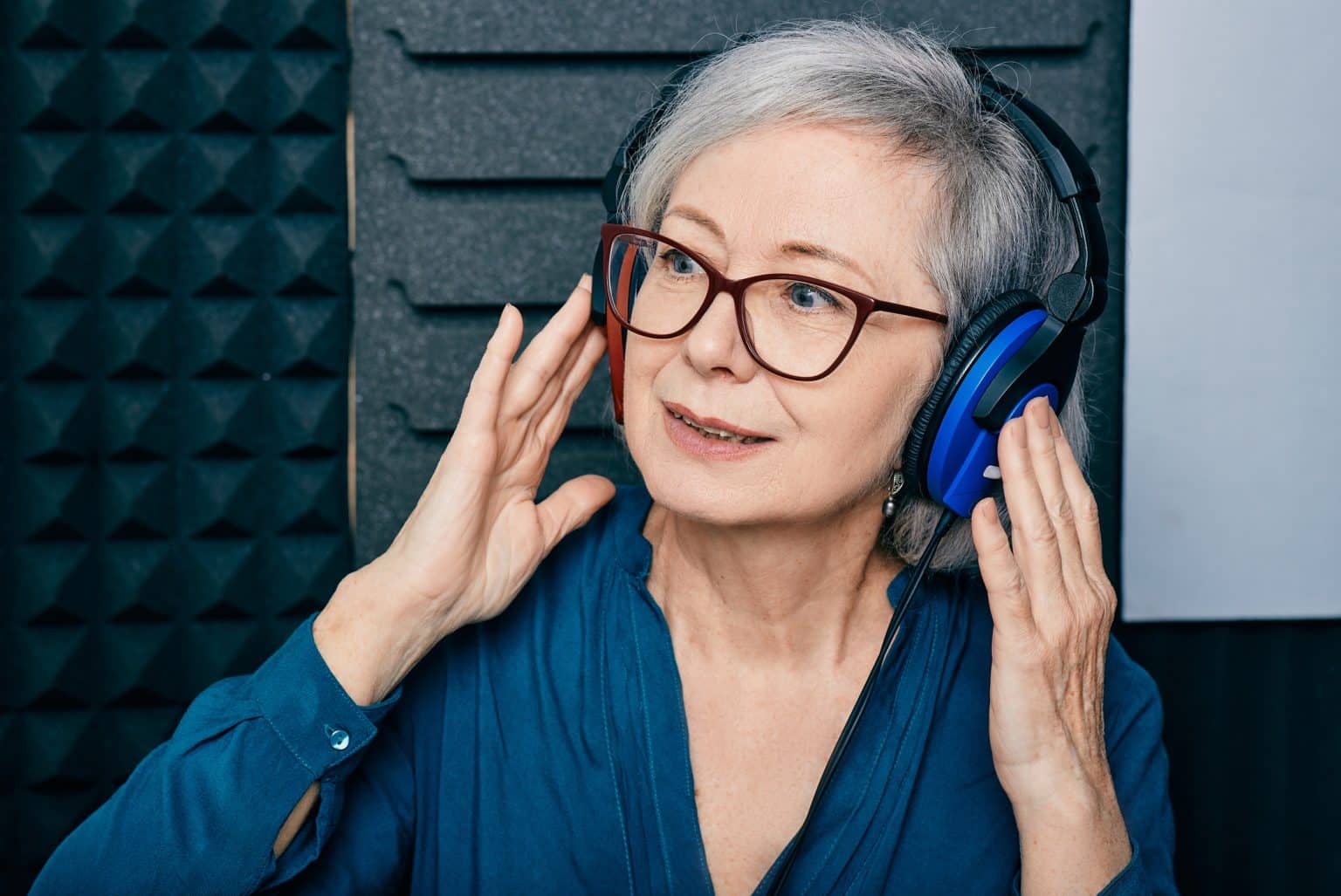 Senior woman wearing headphones during a hearing test.