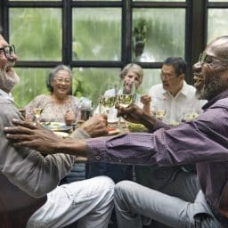 Older friends enjoying a dinner party.