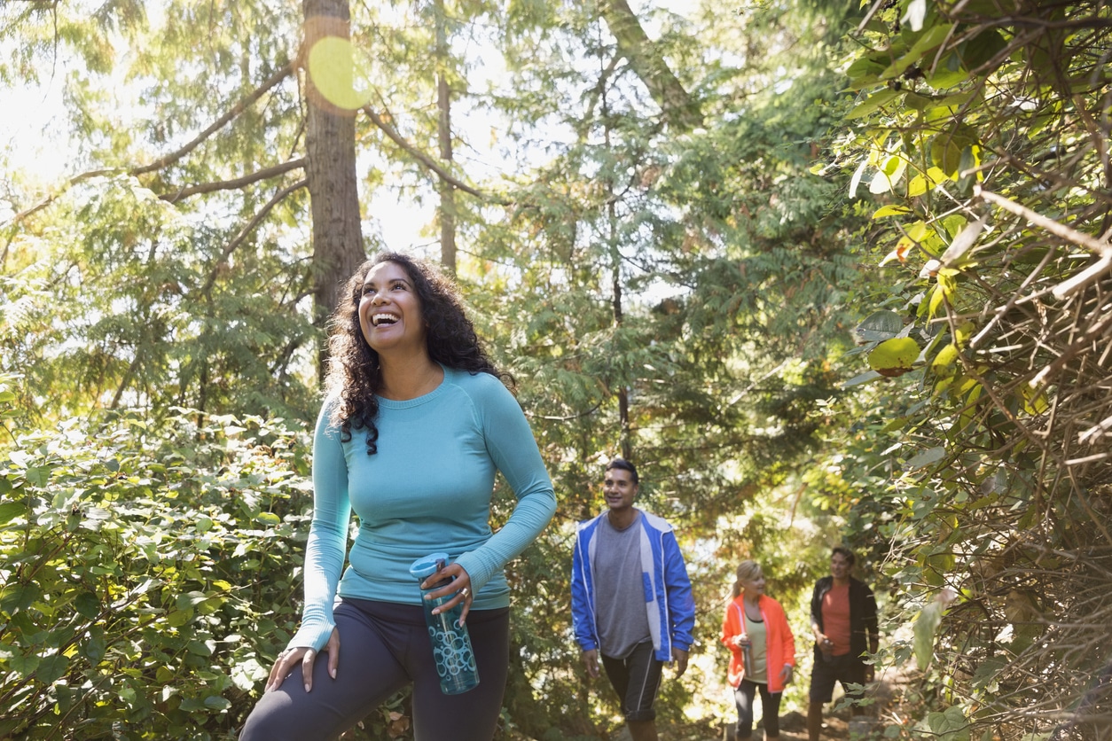 A group of four happy people on a hike together