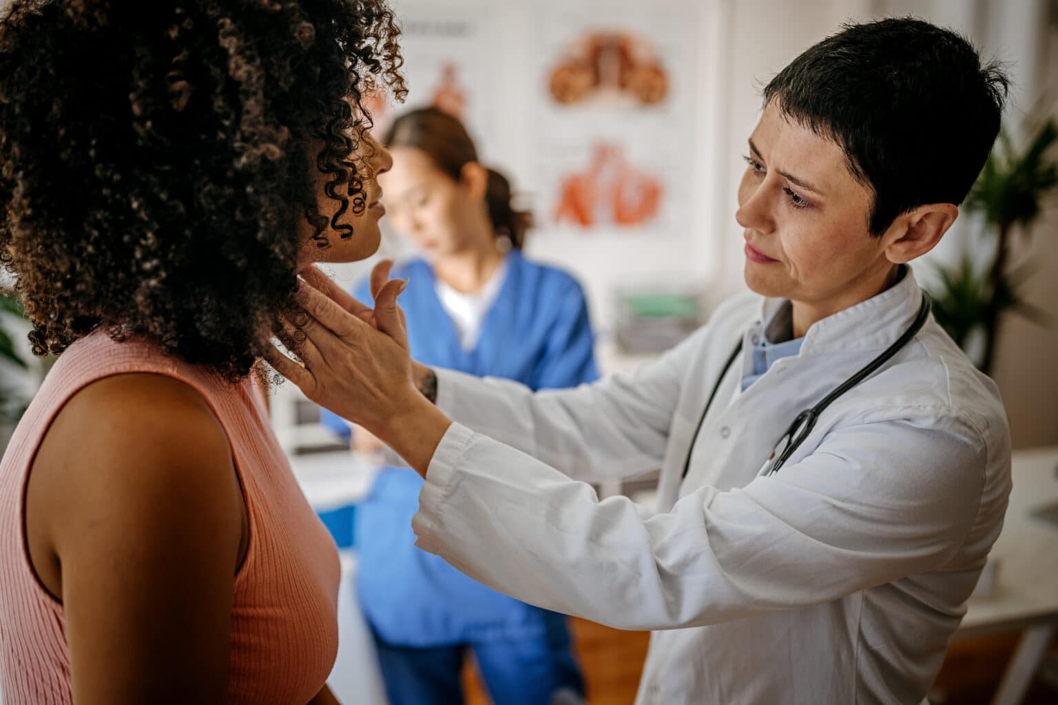 ENT doctor examining a female patient in a medical office.