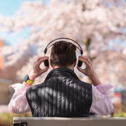 Man puts headphones on in park