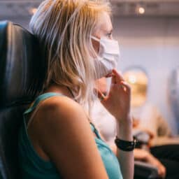 Woman wearing a mask on a plane