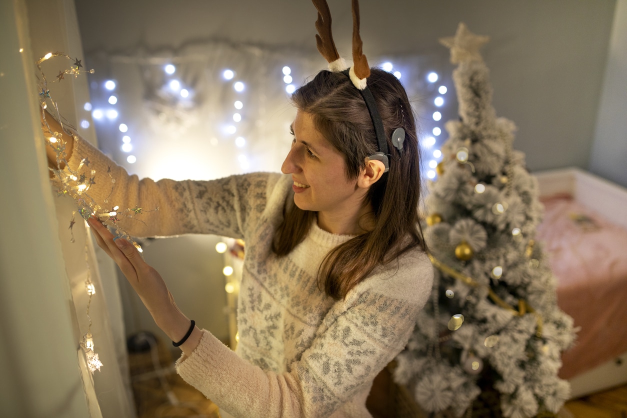 Woman with hearing device decorates for holiday