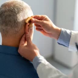 Senior man getting a new hearing aid