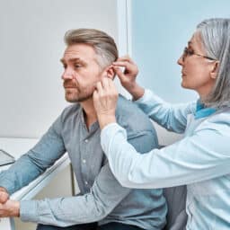 Man with hearing loss is fitted with hearing aid