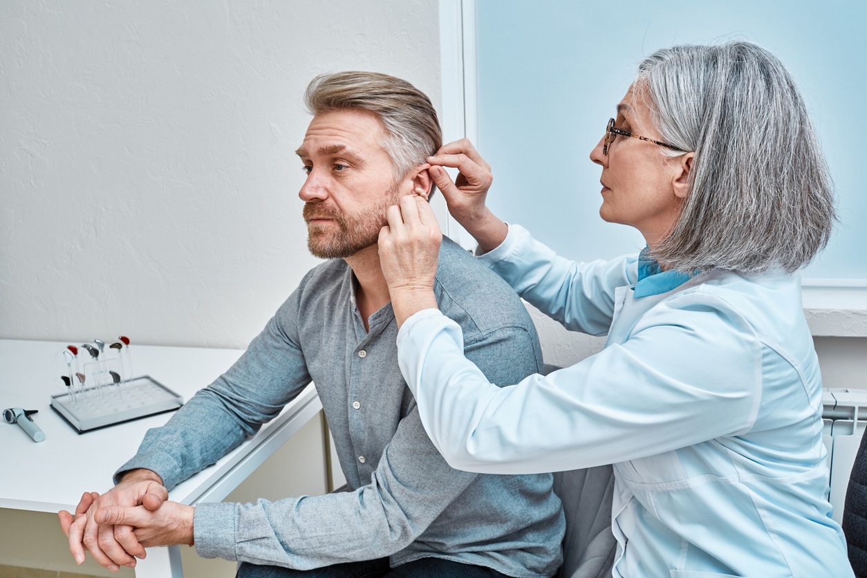 Man with hearing loss is fitted with hearing aid