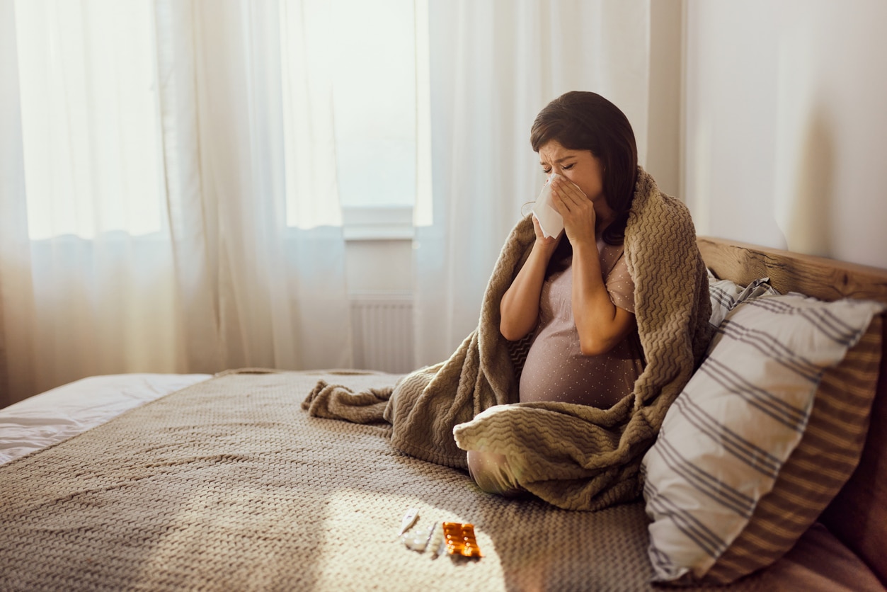 Pregnant woman blows nose