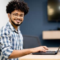 Young man wearing hearing aids and glasses