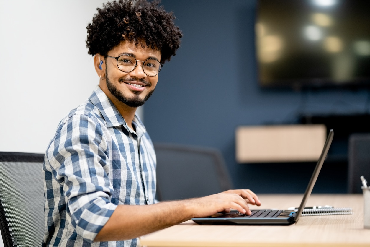 Young man wearing hearing aids and glasses.