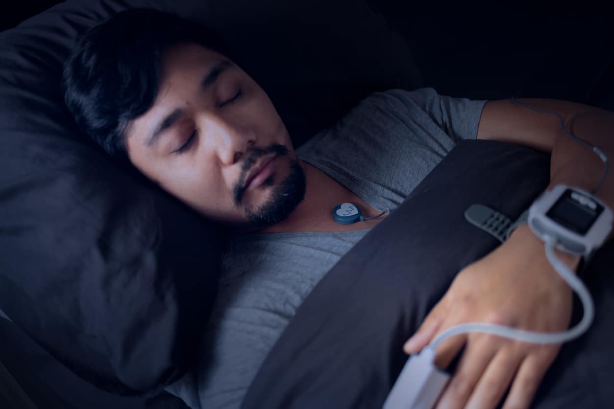 Man Wearing a Pulse Oximeter - At Home Sleep Study Test for Sleep Apnea 